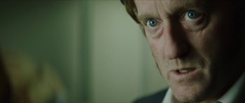 Movie still from “Calm with Horses” (2019), directed by Nick Rowland – A person with a blue eye; Close Up shot, Over the shoulder angle