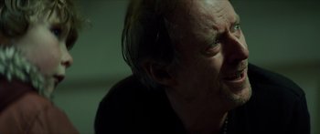 Movie still from “Calm with Horses” (2019), directed by Nick Rowland – An older man with a beard and a mustache; Close Up shot, Over the shoulder angle