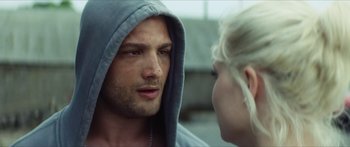 Movie still from “Calm with Horses” (2019), directed by Nick Rowland – A man in a hooded sweatshirt talking to a woman in front of a building; Close Up shot, Over the shoulder angle