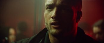 Movie still from “Calm with Horses” (2019), directed by Nick Rowland – A man's face in a dark room; Close Up shot, Low angle