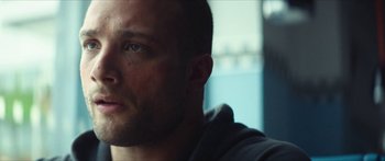 Movie still from “Calm with Horses” (2019), directed by Nick Rowland – A man's face in a dark room; Close Up shot, Low angle