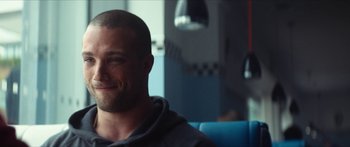 Movie still from “Calm with Horses” (2019), directed by Nick Rowland – A person sitting in a chair; Close Up shot, Over the shoulder angle