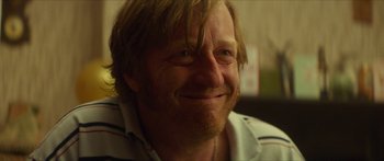 Movie still from “Calm with Horses” (2019), directed by Nick Rowland – A person with long hair; Close Up shot, Over the shoulder angle