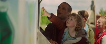 Movie still from “Calm with Horses” (2019), directed by Nick Rowland – A man and a child looking out a window; Close Up shot, Low angle