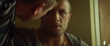 Movie still from “Calm with Horses” (2019), directed by Nick Rowland – A person looking at a mirror; Close Up shot, Over the shoulder angle