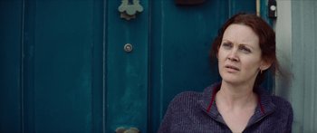 Movie still from “Calm with Horses” (2019), directed by Nick Rowland – A woman standing in front of a blue door; Close Up shot, Over the shoulder angle