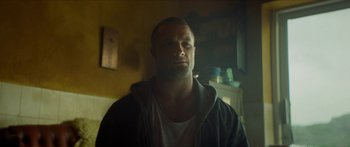 Movie still from “Calm with Horses” (2019), directed by Nick Rowland – A person in a room; Close Up shot, Low angle