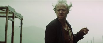 Movie still from “Calm with Horses” (2019), directed by Nick Rowland – An old man with a long white beard is looking at the camera; Close Up shot, Low angle