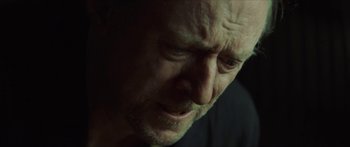 Movie still from “Calm with Horses” (2019), directed by Nick Rowland – A man's face in a dimly - lit room; Close Up shot, Low angle