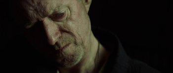 Movie still from “Calm with Horses” (2019), directed by Nick Rowland – An old man with a beard and a mustache; Extreme Close Up shot, Over the shoulder angle