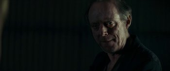 Movie still from “Calm with Horses” (2019), directed by Nick Rowland – A person wearing a black shirt; Close Up shot, Over the shoulder angle