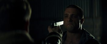 Movie still from “Calm with Horses” (2019), directed by Nick Rowland – A man holding a gun up to his face; Close Up shot, Over the shoulder angle
