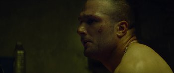 Movie still from “Calm with Horses” (2019), directed by Nick Rowland – A person with a bruise on his face; Close Up shot, Low angle