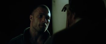 Movie still from “Calm with Horses” (2019), directed by Nick Rowland – A person looking at a mirror; Close Up shot, Over the shoulder angle