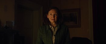 Movie still from “Calm with Horses” (2019), directed by Nick Rowland – An older woman standing in a dark room; Close Up shot, Over the shoulder angle