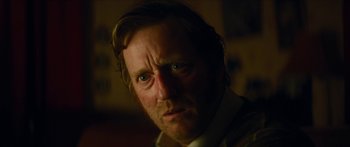 Movie still from “Calm with Horses” (2019), directed by Nick Rowland – A person looking at the camera; Close Up shot, Over the shoulder angle