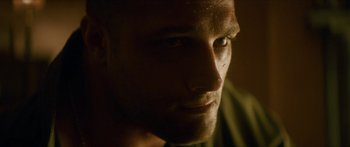 Movie still from “Calm with Horses” (2019), directed by Nick Rowland – A man's face in the dark; Close Up shot, Low angle