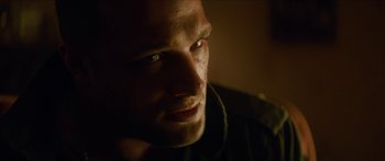 Movie still from “Calm with Horses” (2019), directed by Nick Rowland – A person wearing a black shirt; Close Up shot, Over the shoulder angle