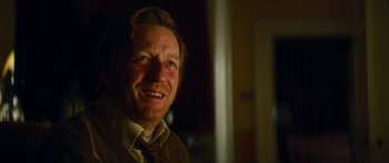 Movie still from “Calm with Horses” (2019), directed by Nick Rowland – A person wearing a suit and tie; Close Up shot, Over the shoulder angle