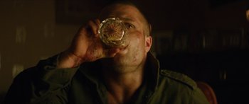 Movie still from “Calm with Horses” (2019), directed by Nick Rowland – A person drinking a glass of water; Close Up shot, Low angle