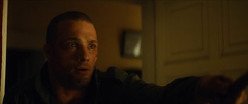 Movie still from “Calm with Horses” (2019), directed by Nick Rowland – A person in a dark room; Close Up shot, Over the shoulder angle