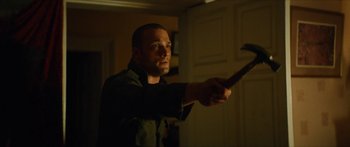 Movie still from “Calm with Horses” (2019), directed by Nick Rowland – A man holding a wii remote in his hand; Medium shot, Low angle