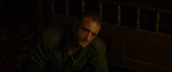 Movie still from “Calm with Horses” (2019), directed by Nick Rowland – A person sitting on the ground; Close Up shot, High angle