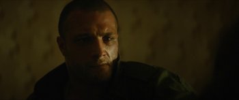 Movie still from “Calm with Horses” (2019), directed by Nick Rowland – A person looking at the camera; Close Up shot, Low angle