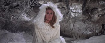 Movie still from “Camelot” (1967), directed by Joshua Logan – A woman in a white coat and a white hood; Medium shot, High angle