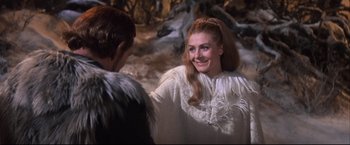 Movie still from “Camelot” (1967), directed by Joshua Logan – A woman in a white dress and a man in a black jacket; Medium shot, Over the shoulder angle