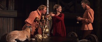 Movie still from “Camelot” (1967), directed by Joshua Logan – A man and a woman are toasting at a party; Medium shot, Low angle