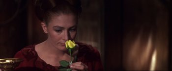 Movie still from “Camelot” (1967), directed by Joshua Logan – A beautiful woman holding a yellow rose in her hand; Close Up shot, Over the shoulder angle