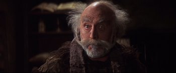 Movie still from “Camelot” (1967), directed by Joshua Logan – An old man with a beard and a mustache; Close Up shot, Low angle