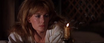 Movie still from “Camelot” (1967), directed by Joshua Logan – A woman sitting in front of a lit candle; Close Up shot, Over the shoulder angle