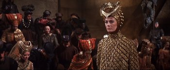 Movie still from “Camelot” (1967), directed by Joshua Logan – A group of people standing in a room; Medium shot, Over the shoulder angle