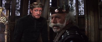 Movie still from “Camelot” (1967), directed by Joshua Logan – Two men in medieval garb looking at each other; Medium shot, Over the shoulder angle