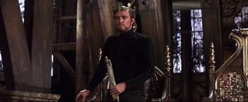 Movie still from “Camelot” (1967), directed by Joshua Logan – A man wearing a crown and holding a staff; Medium shot, Low angle