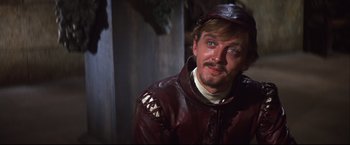 Movie still from “Camelot” (1967), directed by Joshua Logan – A person wearing a leather jacket; Close Up shot, Over the shoulder angle