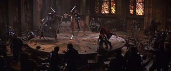 Movie still from “Camelot” (1967), directed by Joshua Logan – A group of people are playing a game in the middle of a room; Wide shot, High angle