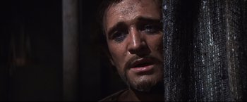 Movie still from “Camelot” (1967), directed by Joshua Logan – A person with a beard looking at the camera; Close Up shot, Over the shoulder angle