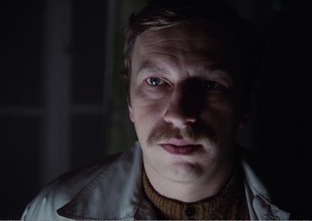 Movie still from “Camera Buff” (1979), directed by Krzysztof Kieslowski – A person with a mustache; Close Up shot, Low angle