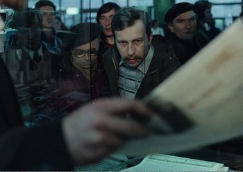 Movie still from “Camera Buff” (1979), directed by Krzysztof Kieslowski – A group of people sitting around a table; Medium shot, Over the shoulder angle