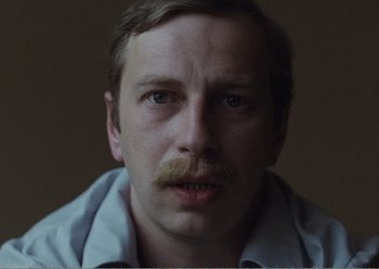 Movie still from “Camera Buff” (1979), directed by Krzysztof Kieslowski – A person with a mustache; Close Up shot, Low angle