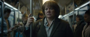 Movie still from “Can You Ever Forgive Me?” (2018), directed by Marielle Heller – A woman standing on a train holding onto a pole; Close Up shot, Low angle