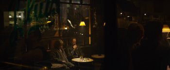 Movie still from “Can You Ever Forgive Me?” (2018), directed by Marielle Heller – Two men sitting at a table in a restaurant; Wide shot, High angle