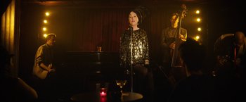 Movie still from “Can You Ever Forgive Me?” (2018), directed by Marielle Heller – An older woman singing in front of an audience; Medium shot, Over the shoulder angle