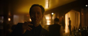 Movie still from “Can You Ever Forgive Me?” (2018), directed by Marielle Heller – A man smoking a cigarette while wearing a suit and tie; Close Up shot, Low angle