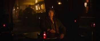 Movie still from “Can You Ever Forgive Me?” (2018), directed by Marielle Heller – A woman sitting at a table in a dark room; Medium shot, Over the shoulder angle