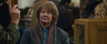 Movie still from “Can You Ever Forgive Me?” (2018), directed by Marielle Heller – An older woman wearing a jacket and a scarf; Close Up shot, Over the shoulder angle