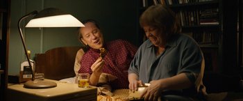 Movie still from “Can You Ever Forgive Me?” (2018), directed by Marielle Heller – A man and a woman sitting at a table eating food; Medium shot, High angle